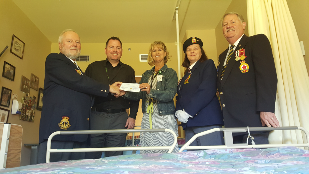 Royal Canadian Legion Branch 160 President Dave Kelly (left) and Poppy Chair John Paulin (far right) present a cheque for $5,000 to Michael Aikins, Manager of The Views and Lynn Dashkewytch, Executive Director of Comox Valley Healthcare Foundation. 