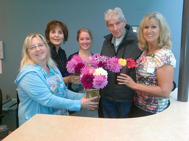 Lorne Millar (aka “The Dahlia Man”) has been bringing his basket of flowers to St. Joseph’s Hospital twice a week for 28 years. Here he is seen with some of the hospital’s front desk staff, as well as Lynn Dashkewytch from the Foundation.